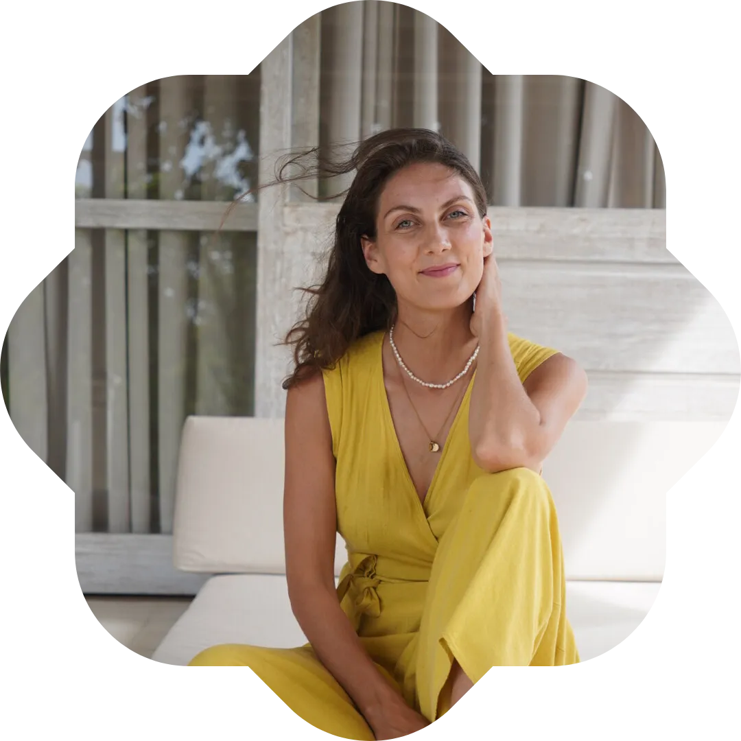 Kristin smiling, sitting in a yellow dress