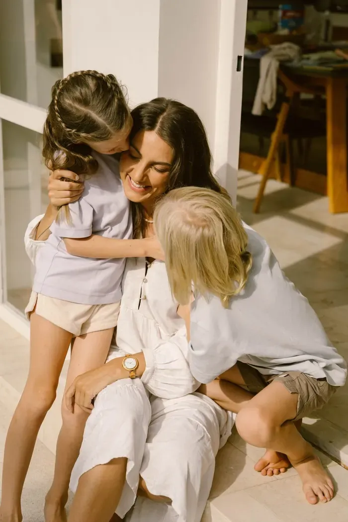 Kristin hugging her two children